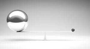 Two metal balls balancing on a white balance beam